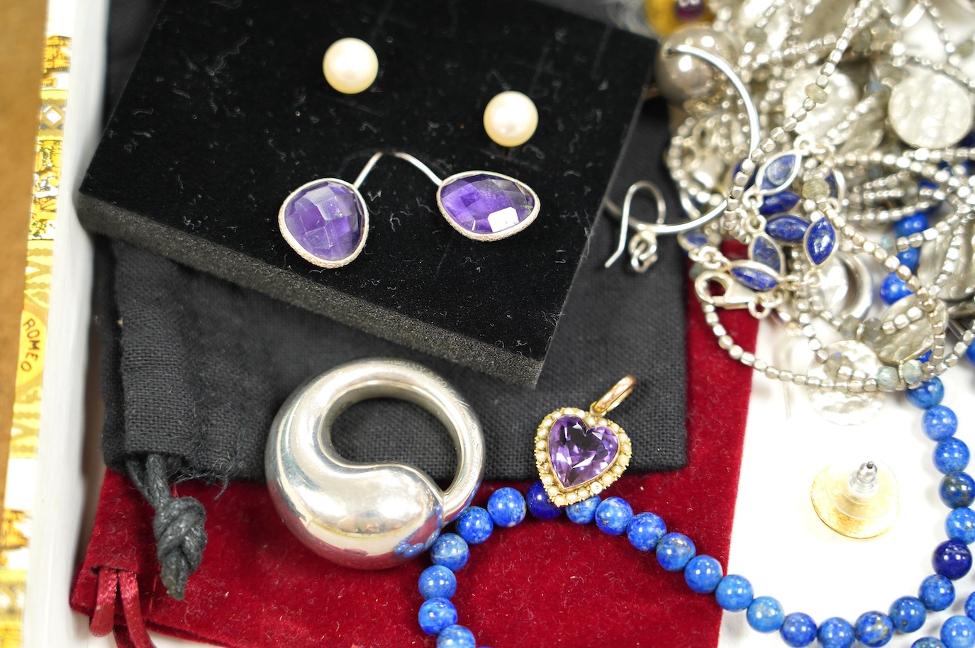 Assorted silver and costume jewellery including a Tiffany Elsa Peretti round circle pendant, 34mm, a lapis lazuli necklace and an amethyst heart pendant. Condition - fair